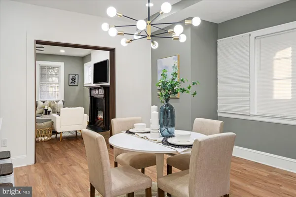 a dining room with furniture potted plants and wooden floor