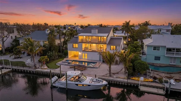 a front view of a house with a yard and tree s