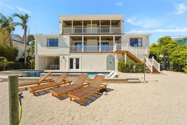 a living room with furniture large window and a fireplace