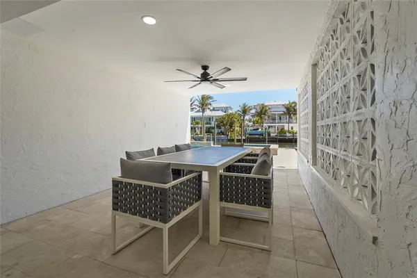 a kitchen with white cabinets stainless steel appliances and wooden floor