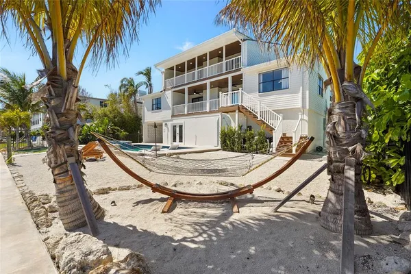 a view of a dining room with furniture wooden floor and a chandelier