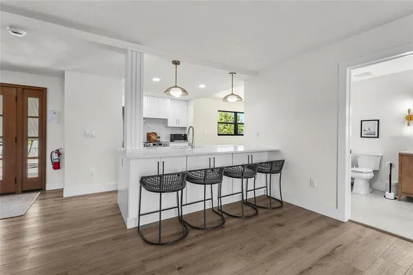 a bathroom with a granite countertop sink a toilet and shower