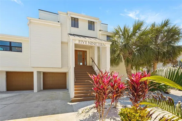 a view of a lake with a yard and large trees