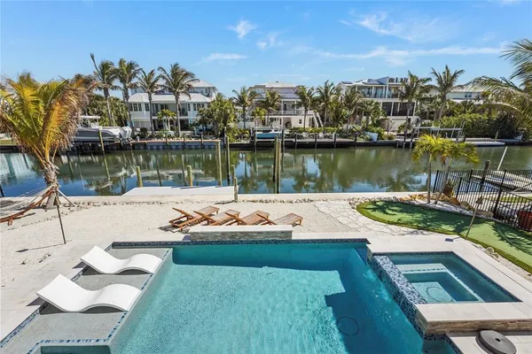 a view of swimming pool with outdoor seating and plants