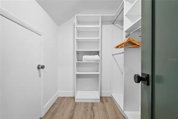 an aerial view of a city with lots of residential buildings and ocean view in back