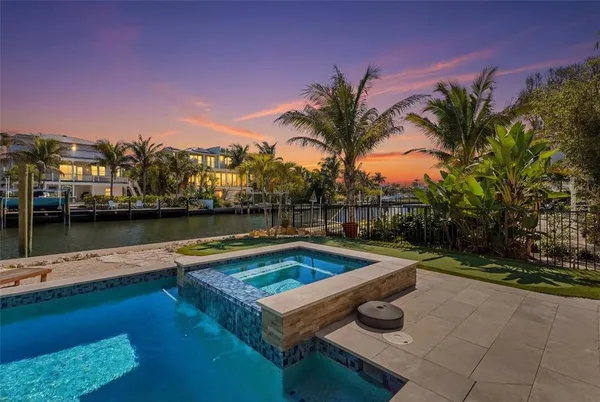 a kitchen with a dining table chairs and cabinets