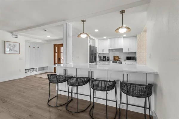 a view of a dining room with furniture wooden floor and chandelier