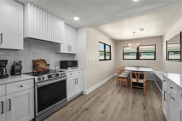 a spacious bathroom with a double vanity sink a large mirror and a bathtub