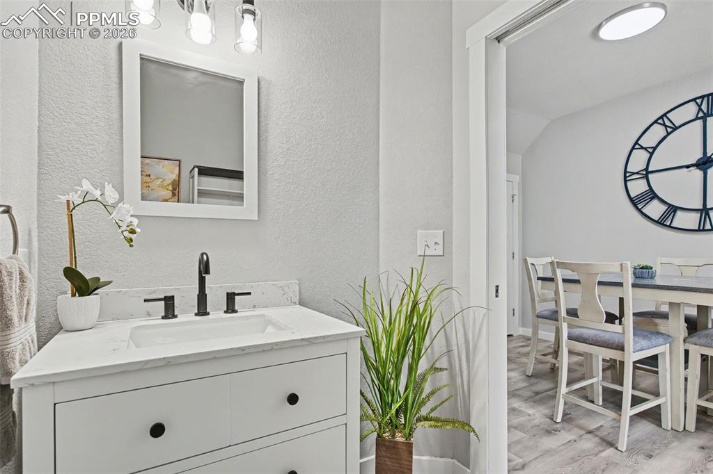 4833 Harrier Ridge Drive Colorado Springs, CO 80916 - Photo 13 of 25 a bathroom with a sink and mirror