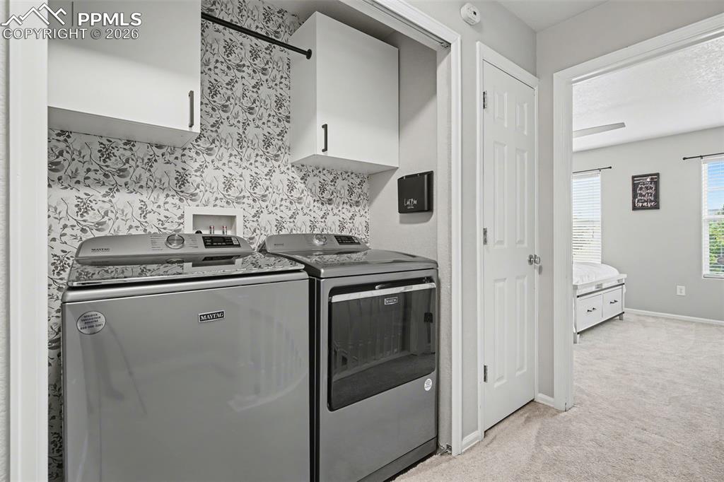 4833 Harrier Ridge Drive Colorado Springs, CO 80916 - Photo 14 of 25 a kitchen with stainless steel appliances a refrigerator and cabinets