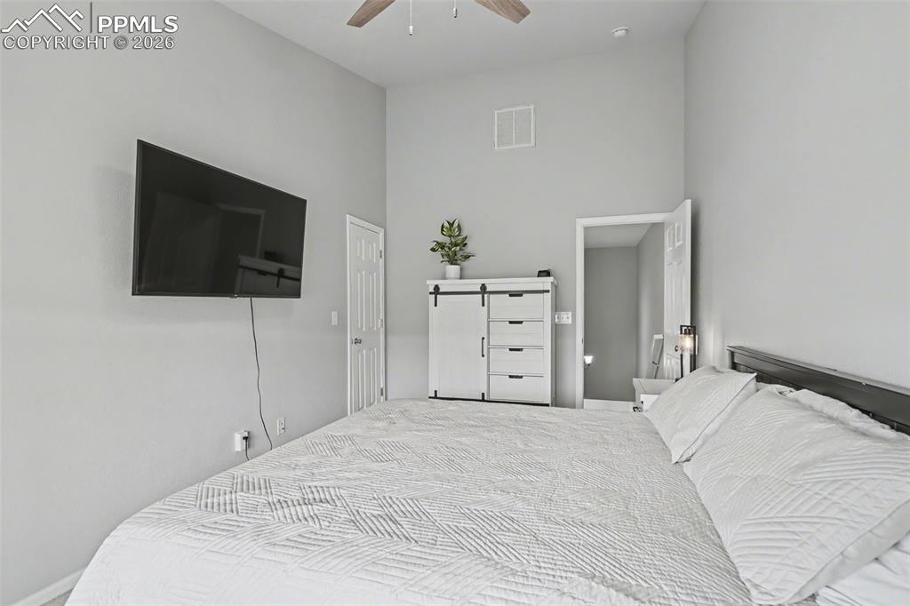4833 Harrier Ridge Drive Colorado Springs, CO 80916 - Photo 17 of 25 a bedroom with a bed and a flat screen tv