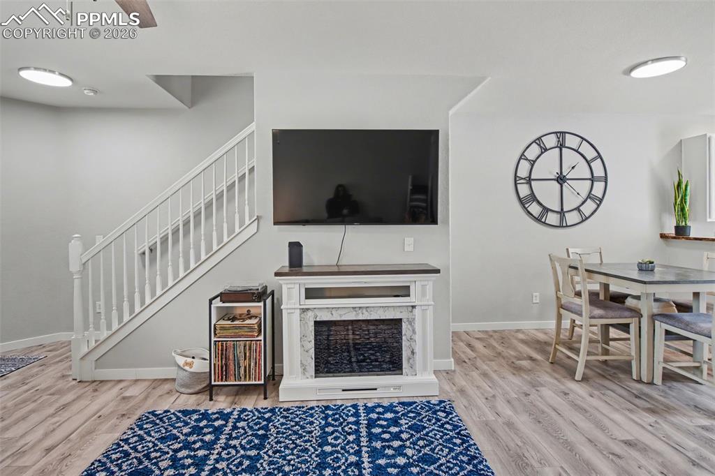 4833 Harrier Ridge Drive Colorado Springs, CO 80916 - Photo 6 of 25 a living room with furniture and a flat screen tv