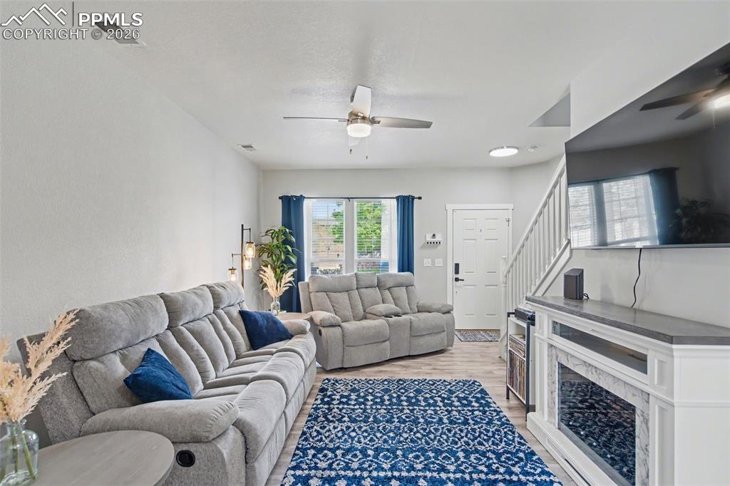 4833 Harrier Ridge Drive Colorado Springs, CO 80916 - Photo 7 of 25 a living room with furniture and a fireplace