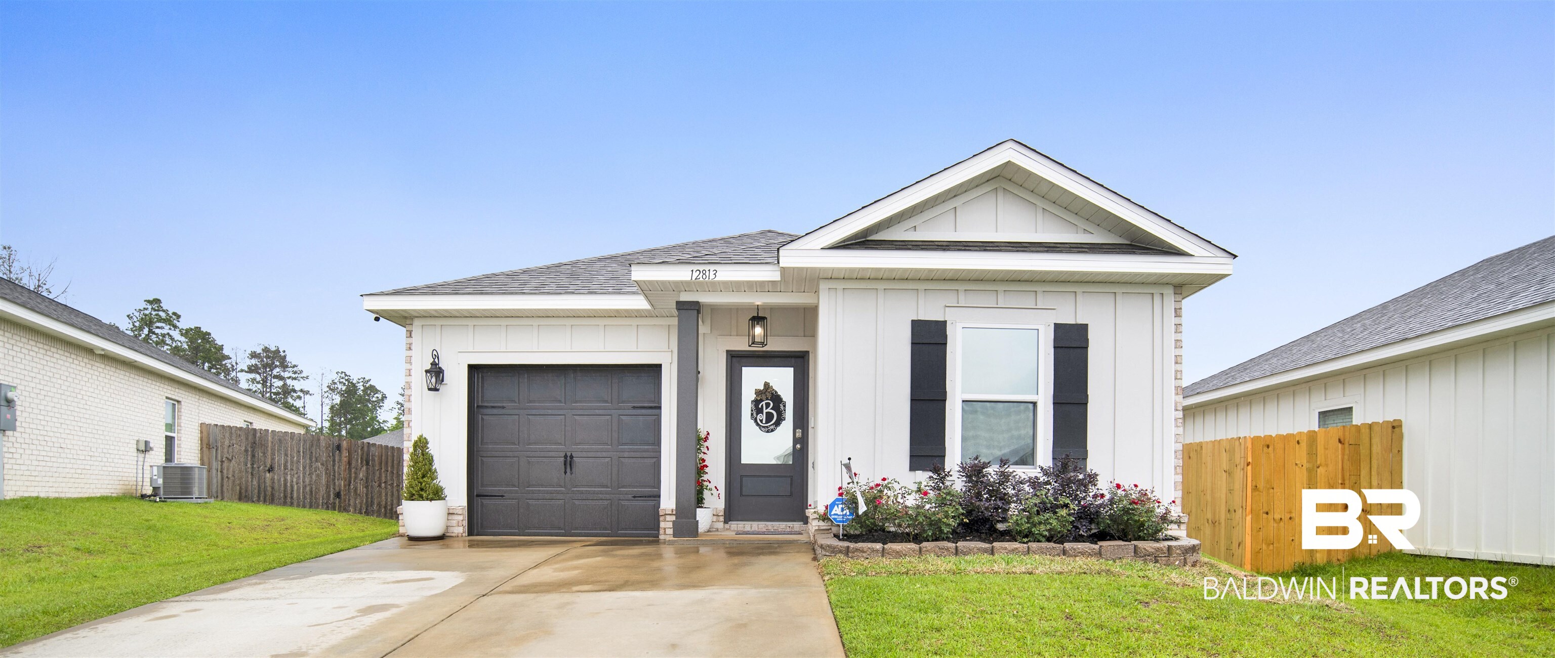 12813 Patriot Way Daphne, AL 36527 - Photo 19 of 23 Single-story residence featuring white vertical siding and a dark gray garage door