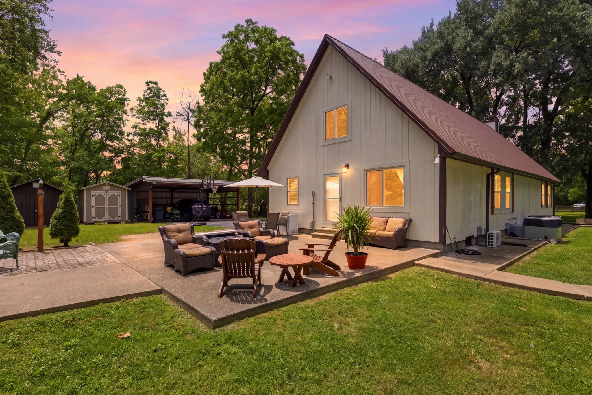 2540 Carl Fox Road Cornersville, TN 37047 - Photo 1 of 48 a view of a backyard with table and chairs potted plants and a large tree