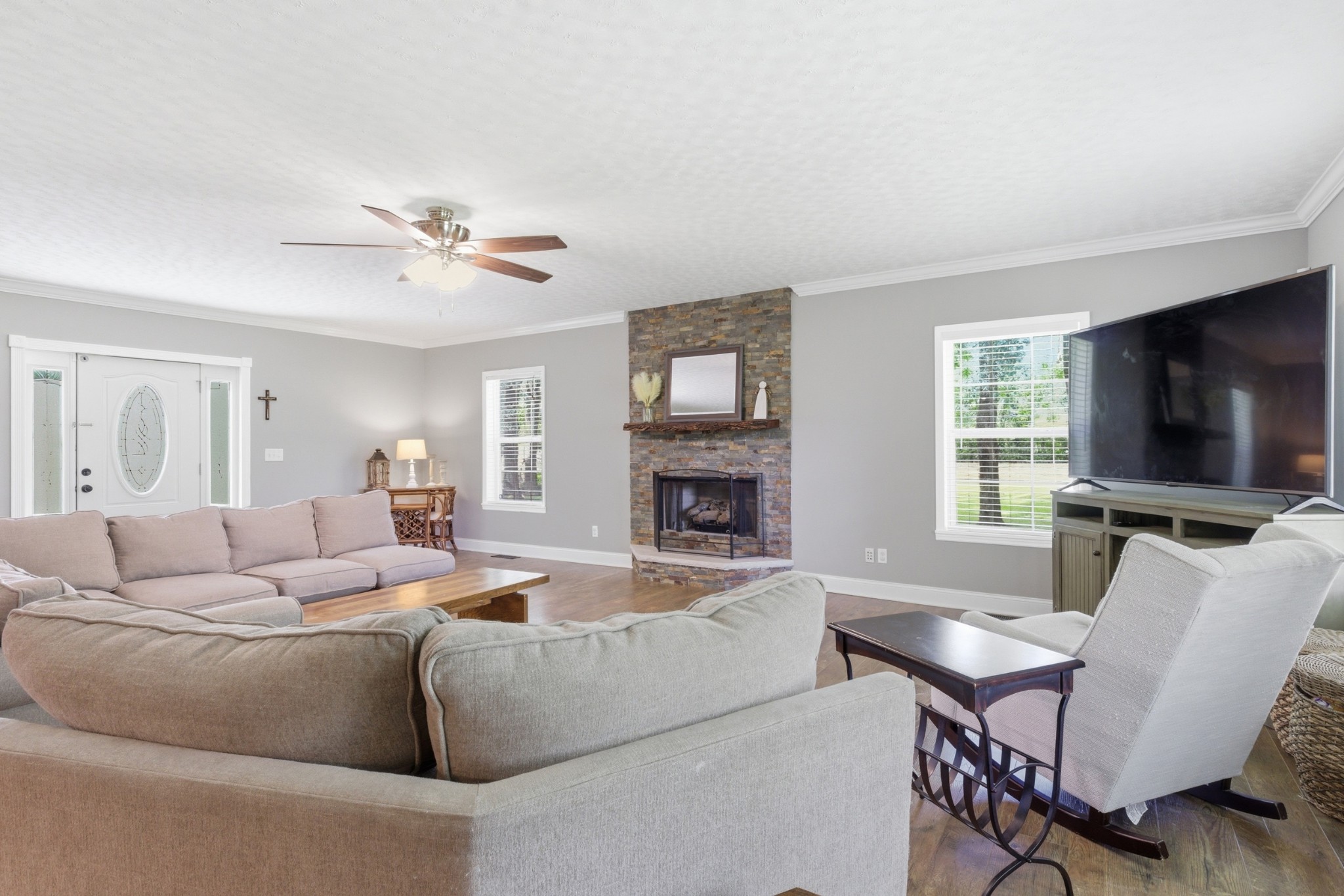 2540 Carl Fox Road Cornersville, TN 37047 - Photo 8 of 48 a living room with furniture a flat screen tv and a fireplace