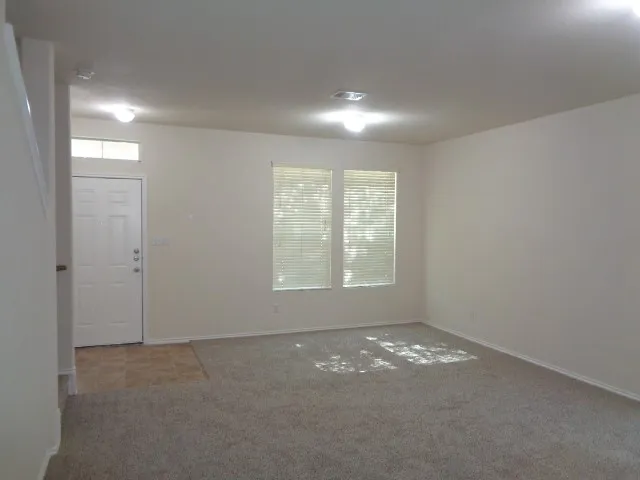 an empty room with windows and closet
