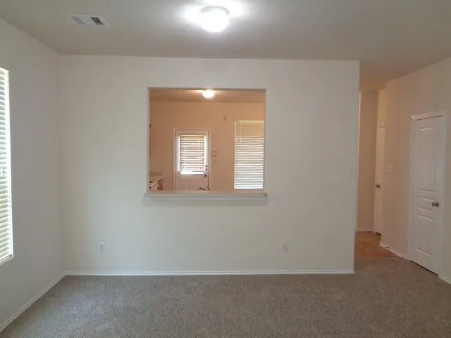 a view of an empty room with a window