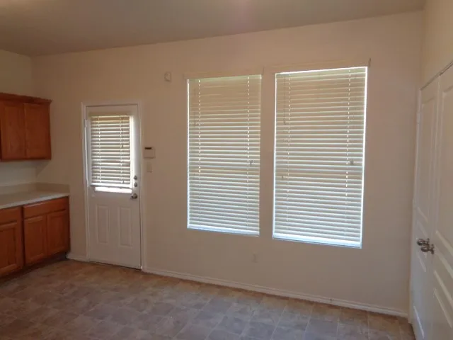 a kitchen with sink a stove and cabinets
