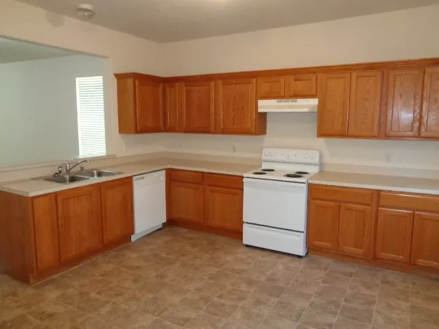 a kitchen with a stove top oven sink and cabinets
