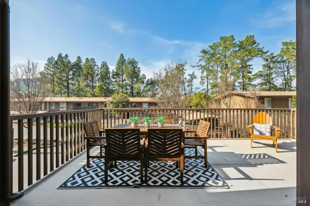 a vase of flowers sitting on a table in front of a window