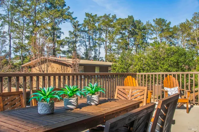 a view of a patio with couches table and chairs and potted plants