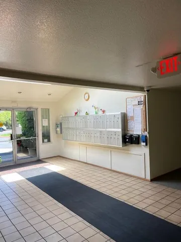 a view of kitchen with refrigerator and window