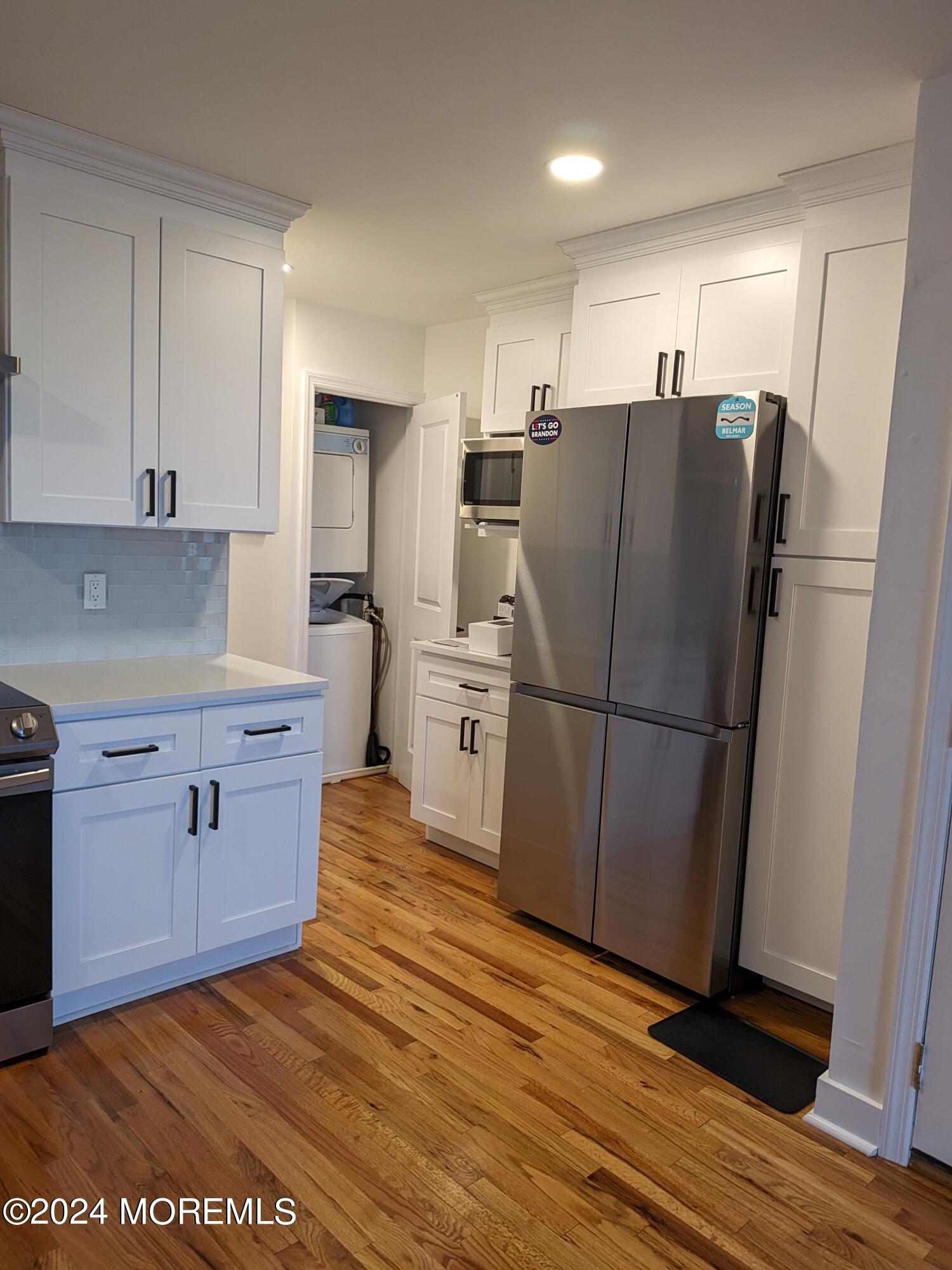 407 Ocean Avenue, Unit 14A WINTER RENTAL Belmar, NJ 07719 - Photo 5 of 8 a kitchen with stainless steel appliances a refrigerator sink and cabinets