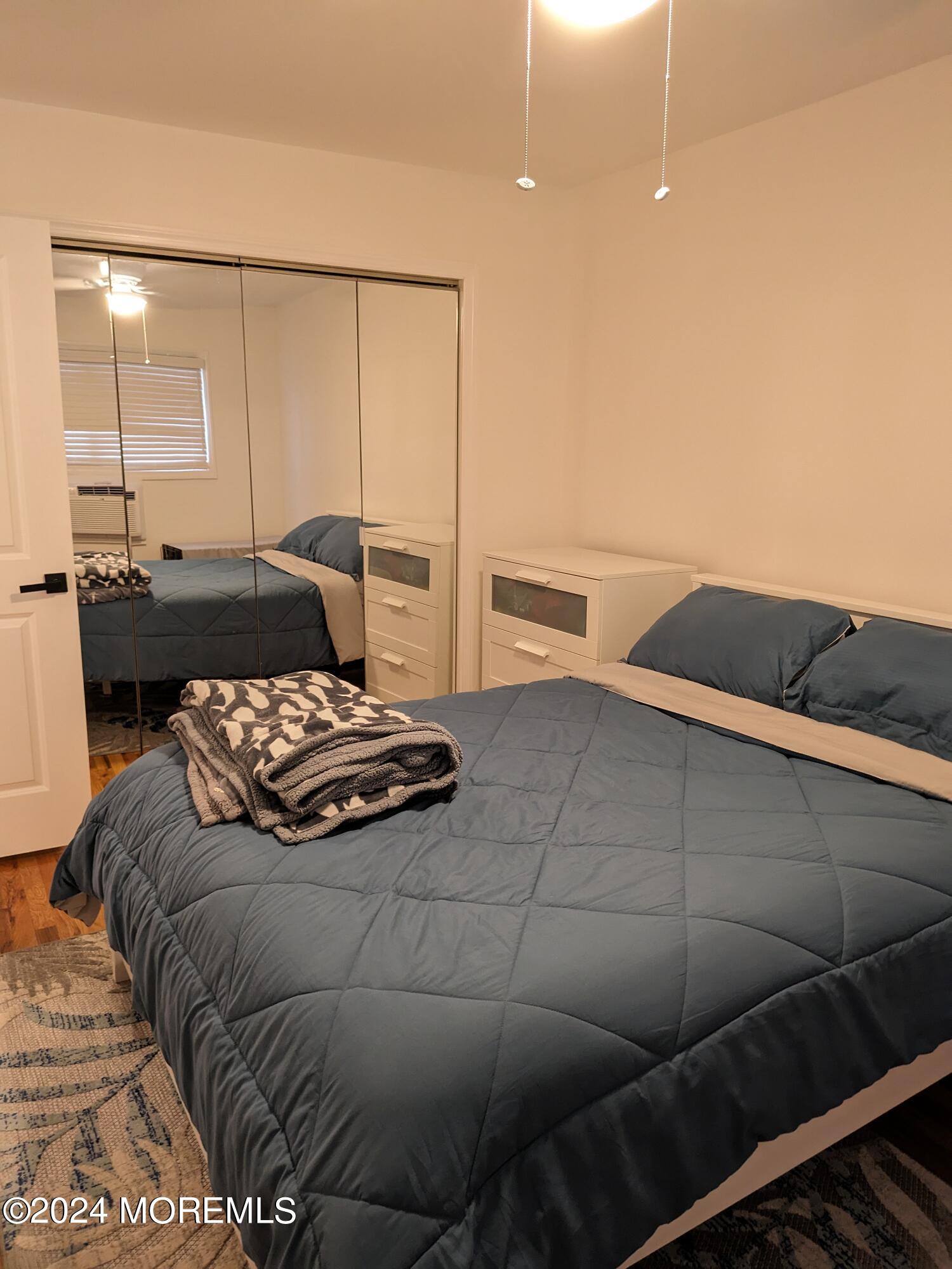 407 Ocean Avenue, Unit 14A WINTER RENTAL Belmar, NJ 07719 - Photo 7 of 8 a bedroom with a bed and ceiling fan