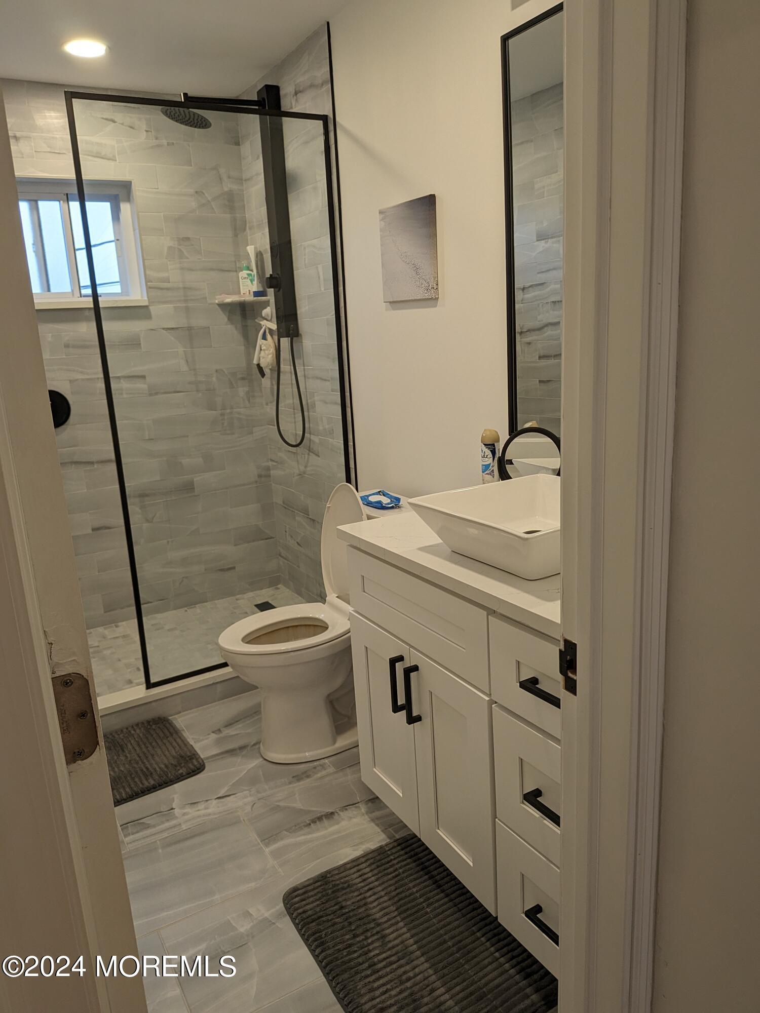 407 Ocean Avenue, Unit 14A WINTER RENTAL Belmar, NJ 07719 - Photo 8 of 8 a bathroom with a sink a toilet and shower