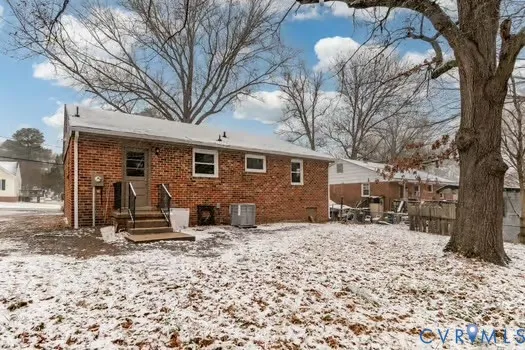 a view of a house with a yard covered in snow