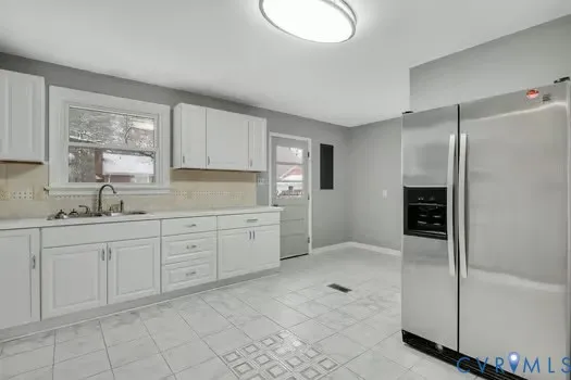 a spacious bathroom with a granite countertop sink a mirror and a bathtub
