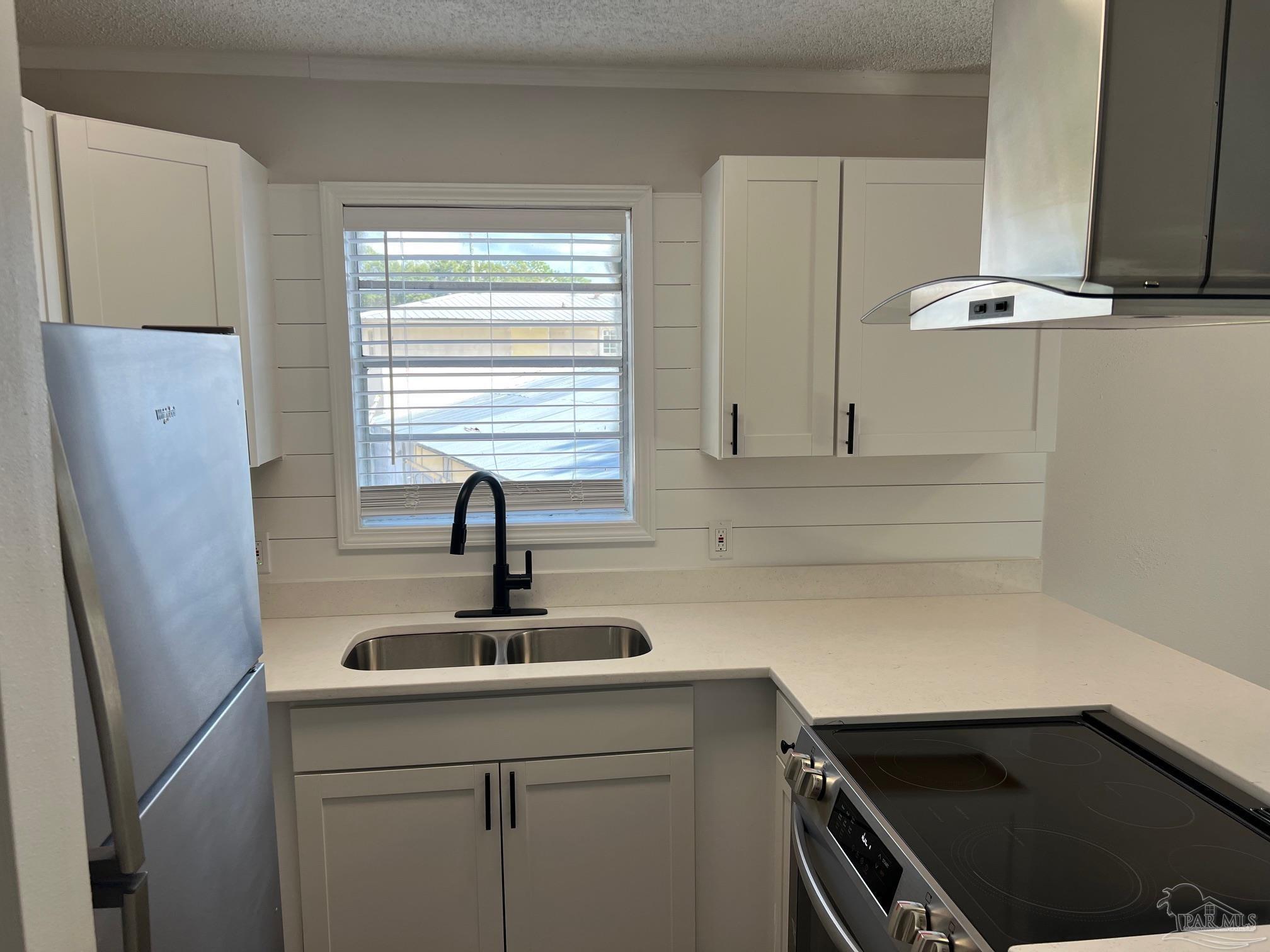 6644 Applegate Street Milton, FL 32570 - Photo 4 of 8 a kitchen with a sink and cabinets