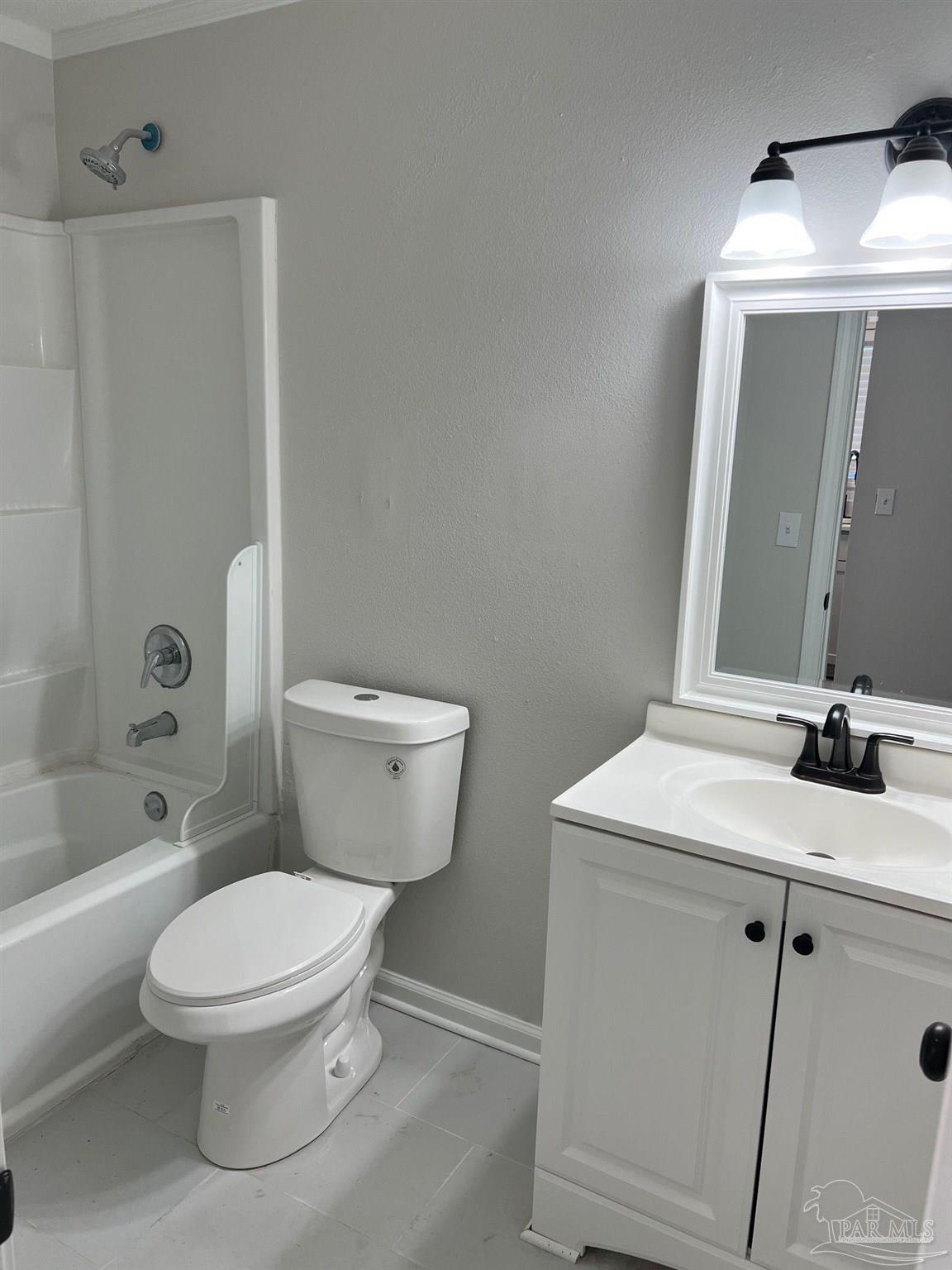 6644 Applegate Street Milton, FL 32570 - Photo 6 of 8 a bathroom with a toilet a sink and a mirror