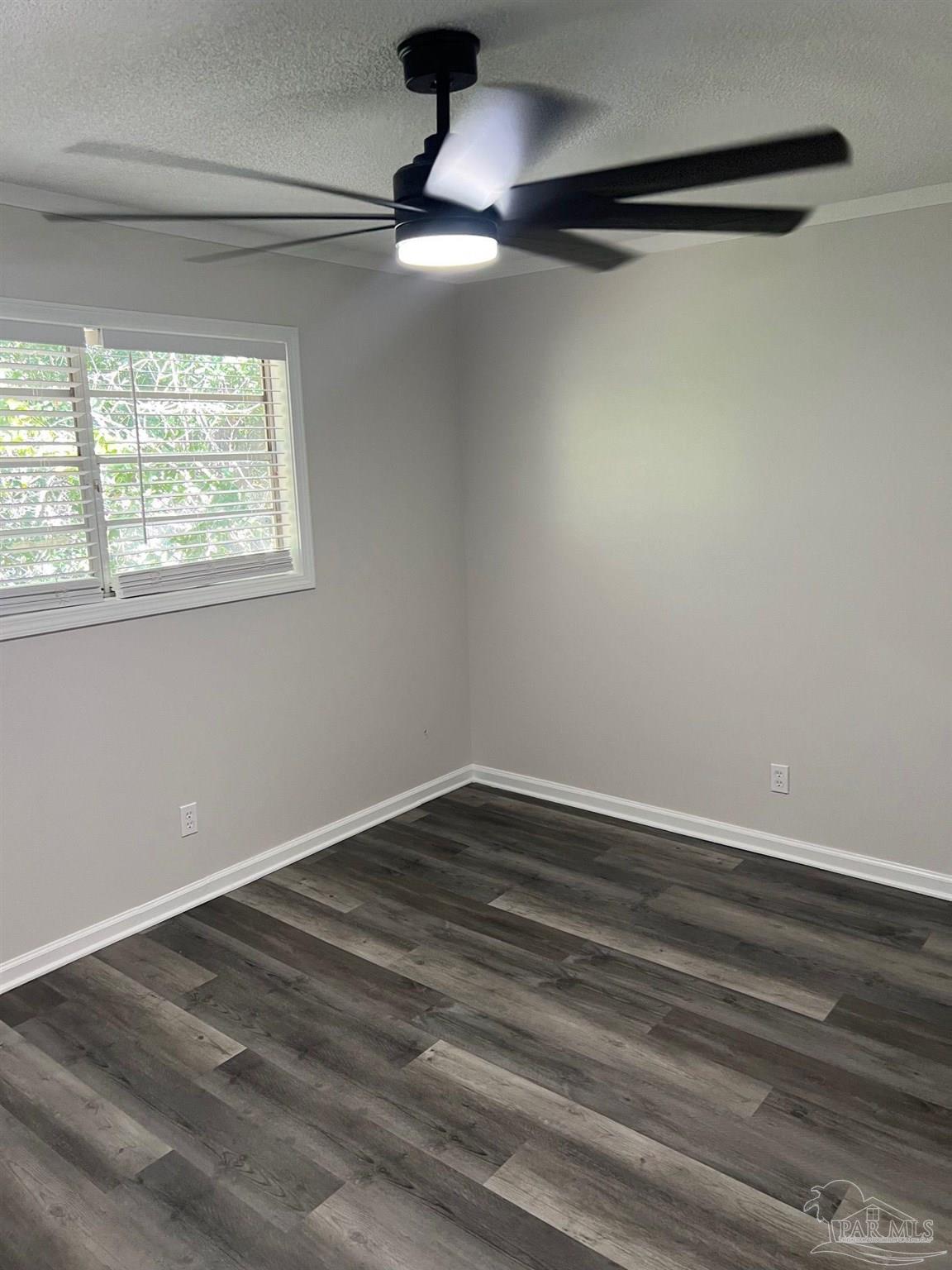 6644 Applegate Street Milton, FL 32570 - Photo 8 of 8 a view of an empty room with wooden floor and a window