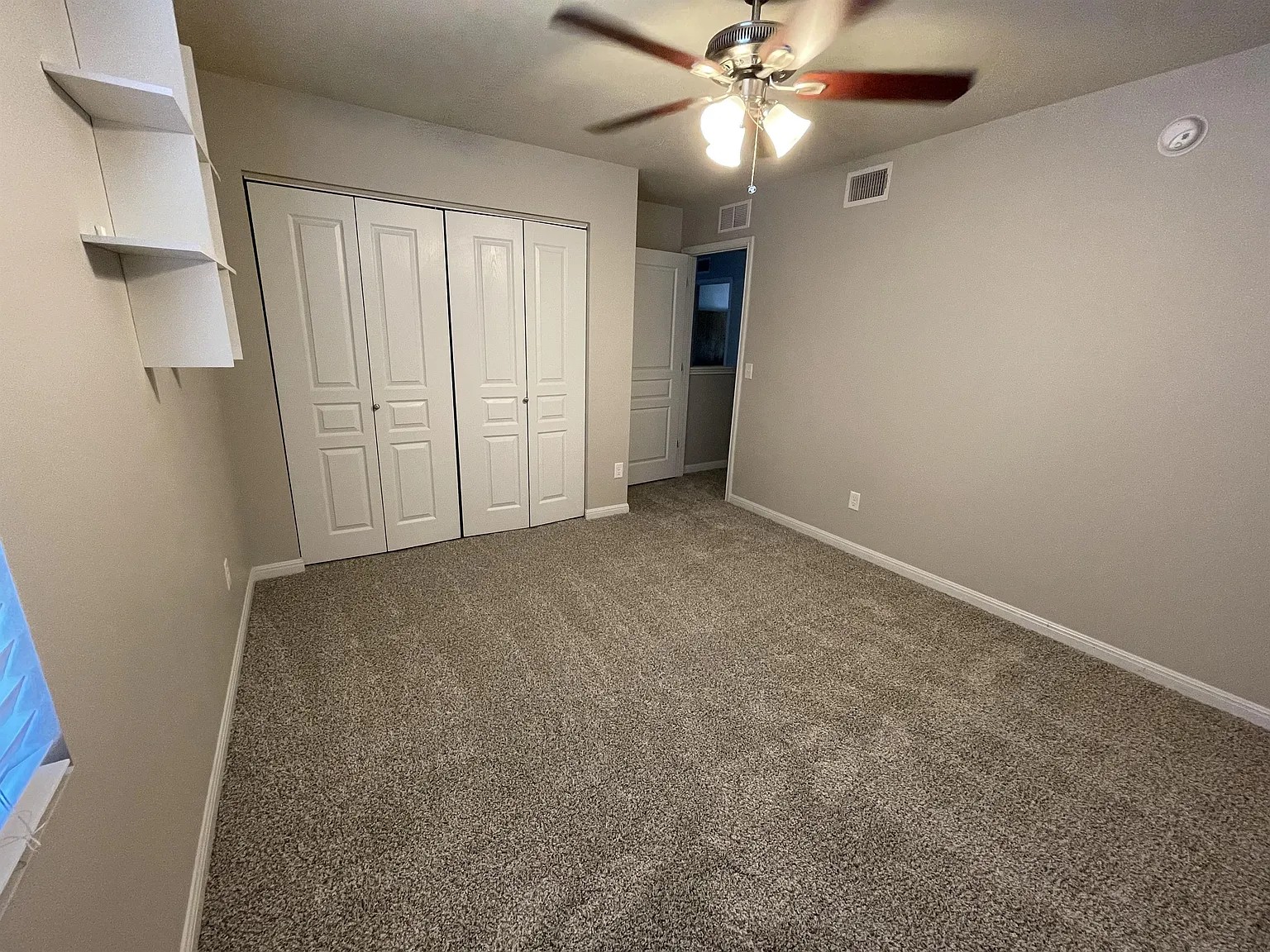 5136 Hellman Kyle, TX 78640 - Photo 12 of 17 Unfurnished bedroom with carpet, a ceiling fan, and a closet