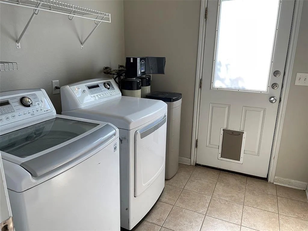 5136 Hellman Kyle, TX 78640 - Photo 17 of 17 Laundry room featuring washer and dryer and light tile patterned floors
