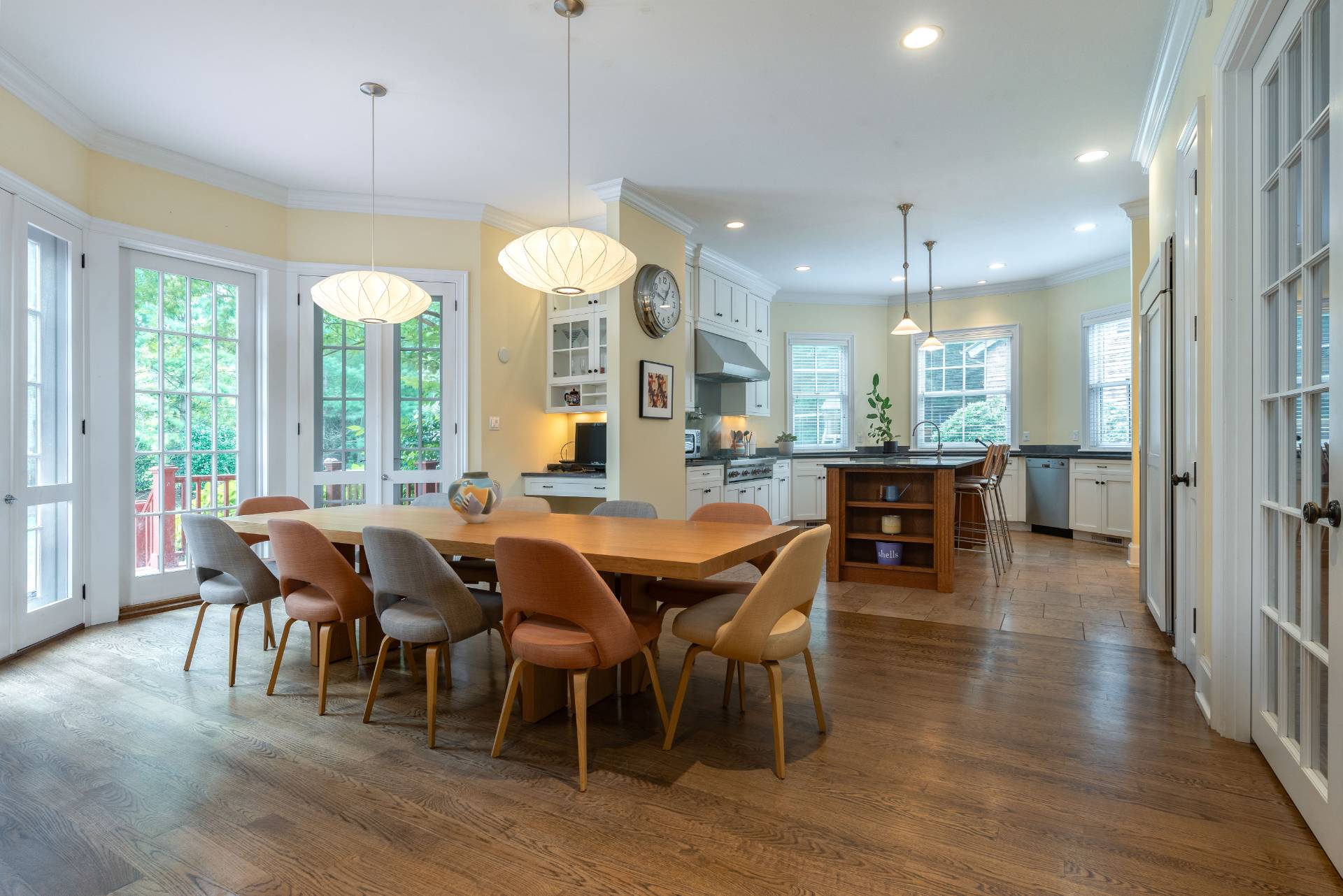 12 Old Point Road Quogue, NY 11959 - Photo 17 of 50 a view of a dining room and livingroom with furniture wooden floor a chandelier