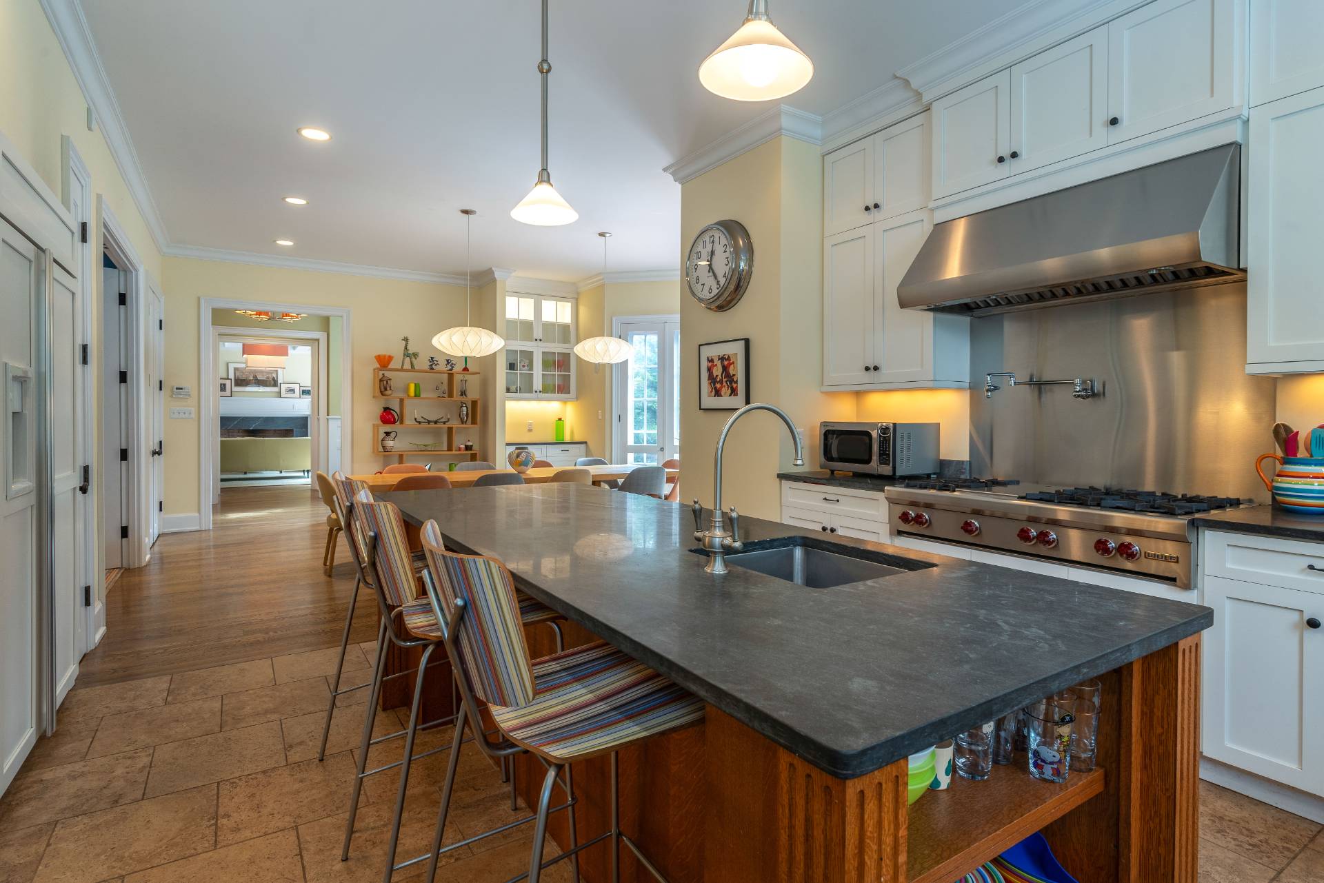 12 Old Point Road Quogue, NY 11959 - Photo 18 of 50 a kitchen with stainless steel appliances granite countertop a stove a refrigerator a kitchen island a sink a stove and white cabinets