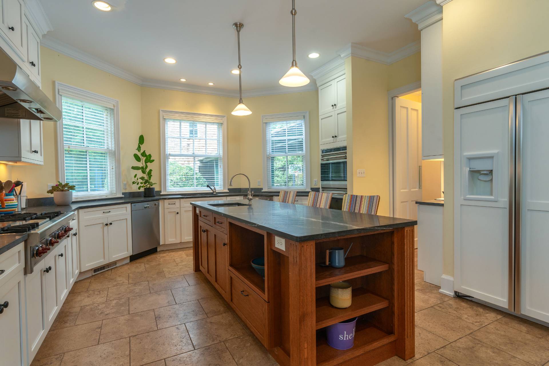 12 Old Point Road Quogue, NY 11959 - Photo 19 of 50 a kitchen with stainless steel appliances granite countertop a stove a sink and a refrigerator