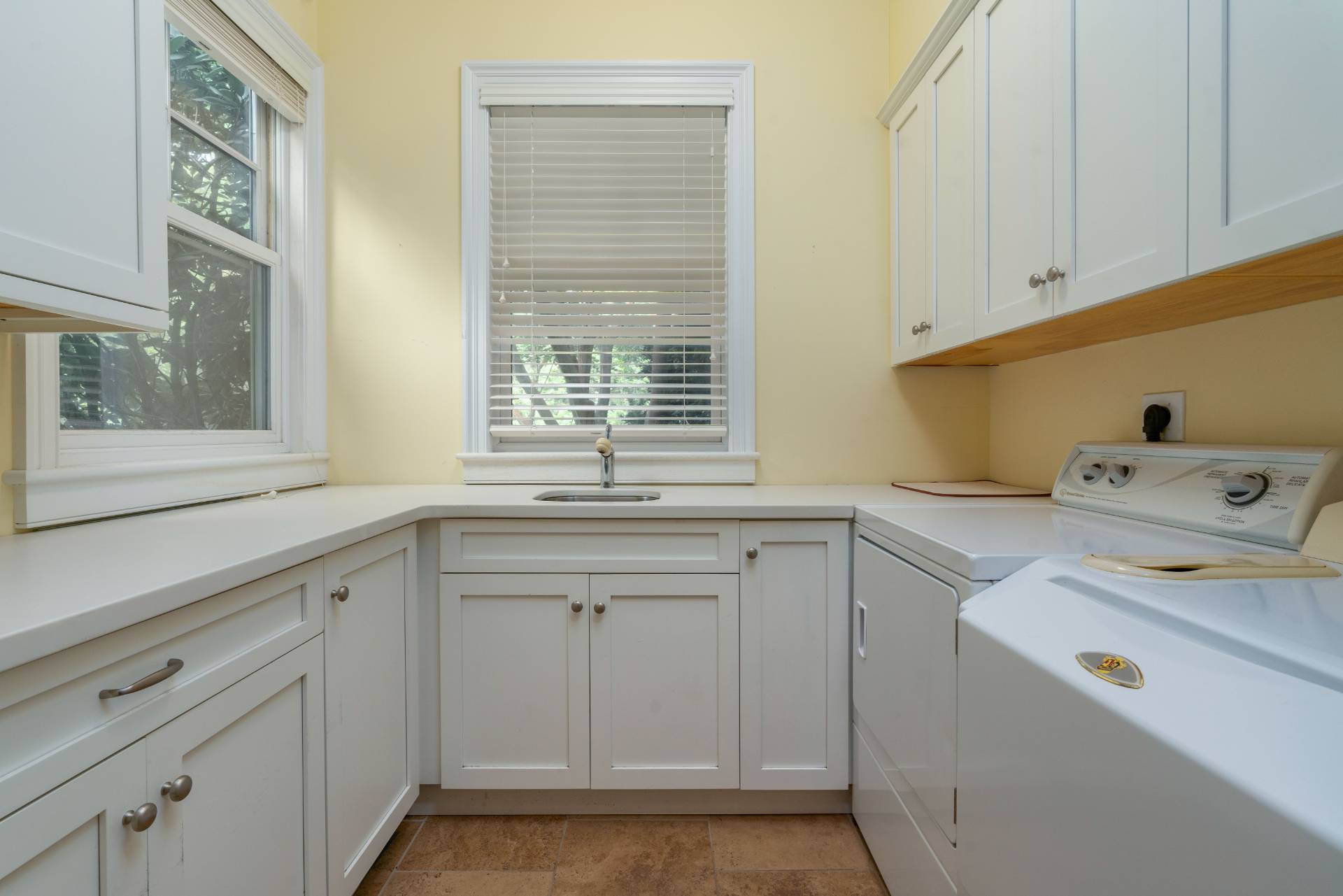 12 Old Point Road Quogue, NY 11959 - Photo 21 of 50 a utility room with cabinets washer and dryer
