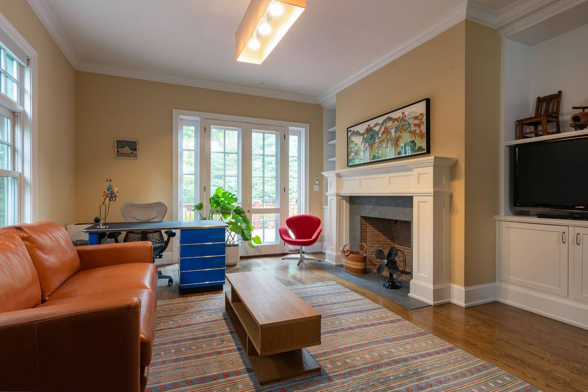 12 Old Point Road Quogue, NY 11959 - Photo 23 of 50 a living room with furniture a flat screen tv and a fireplace