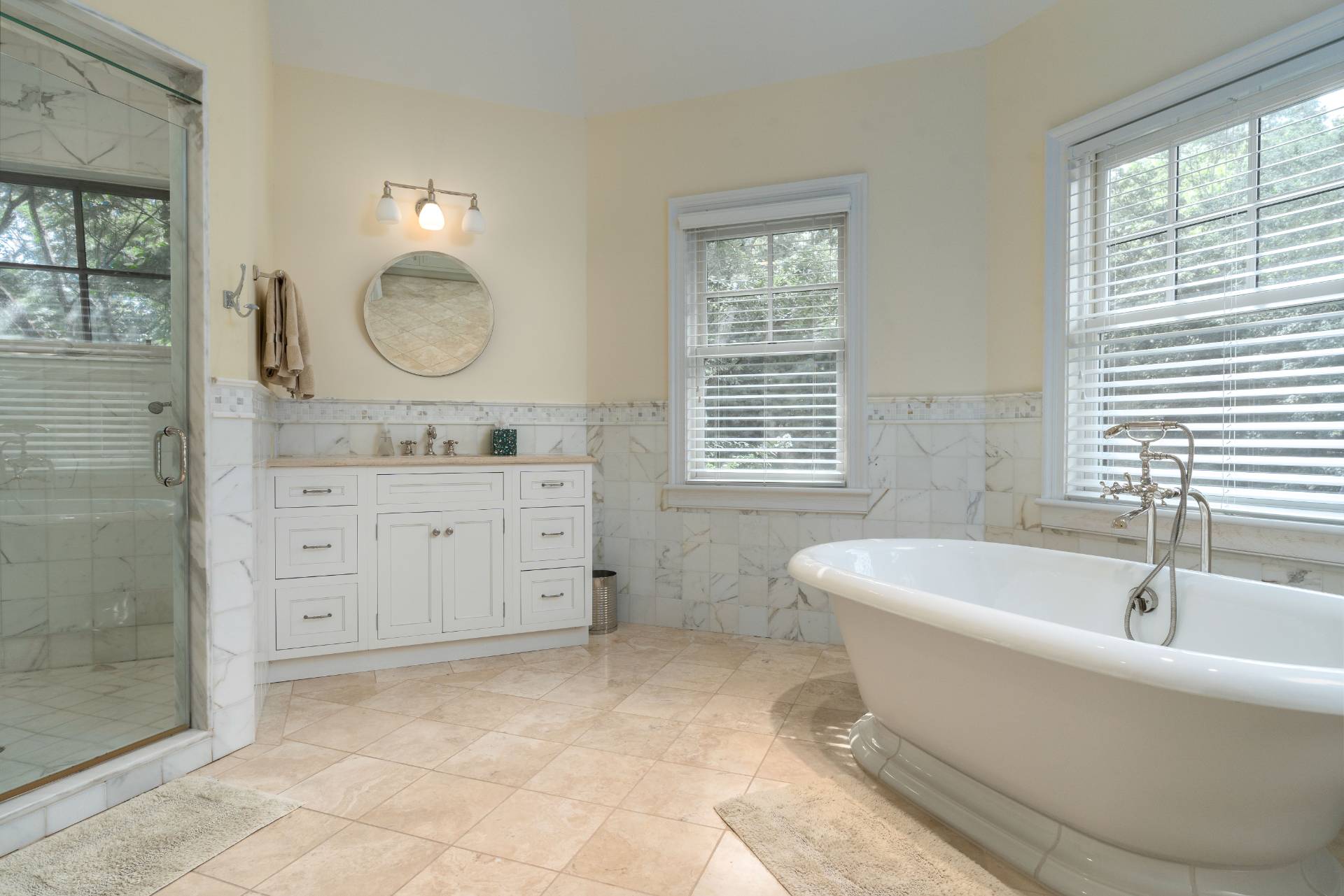 12 Old Point Road Quogue, NY 11959 - Photo 30 of 50 a spacious bathroom with a bathtub sink and mirror