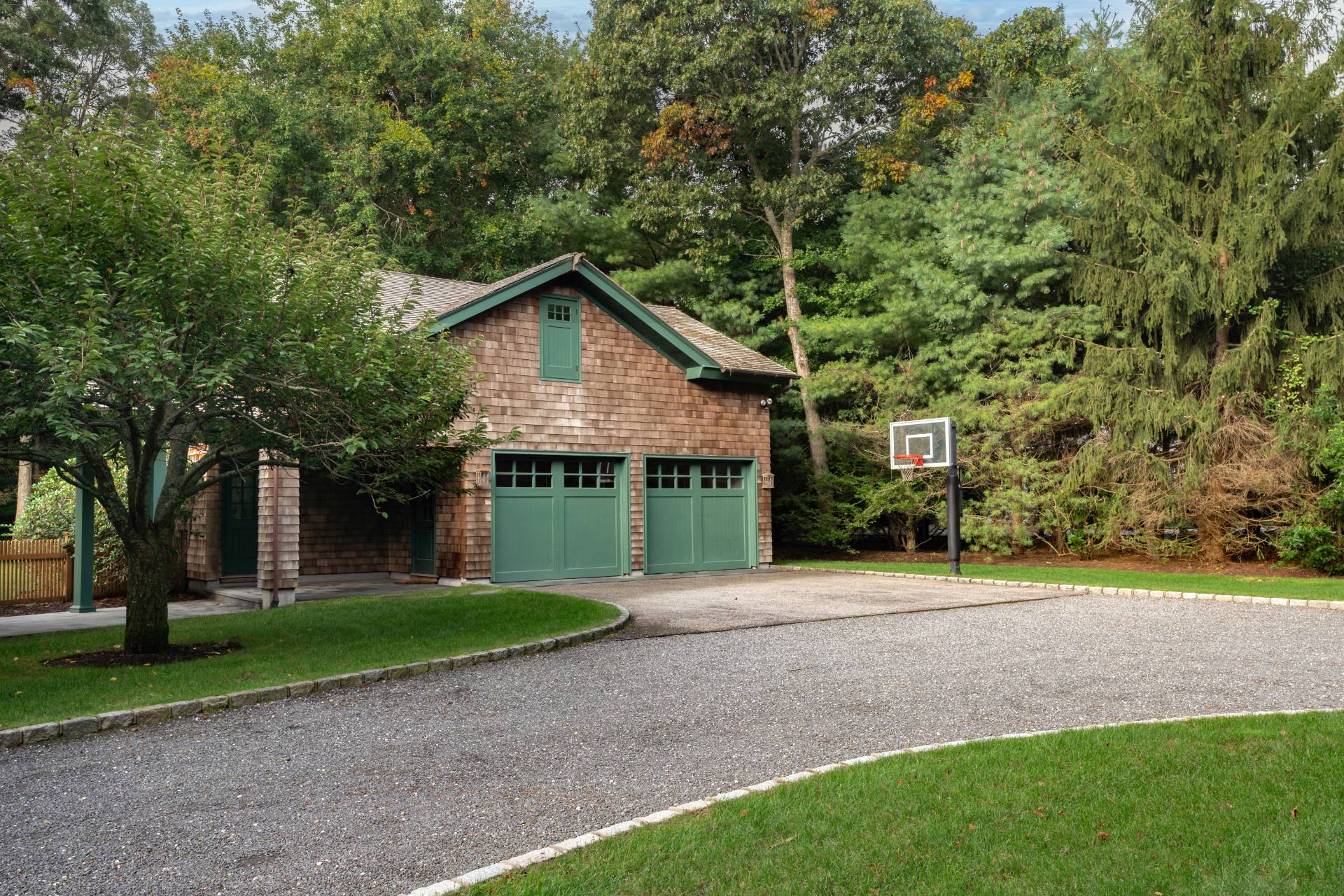 12 Old Point Road Quogue, NY 11959 - Photo 44 of 50 a front view of a house with a yard and trees