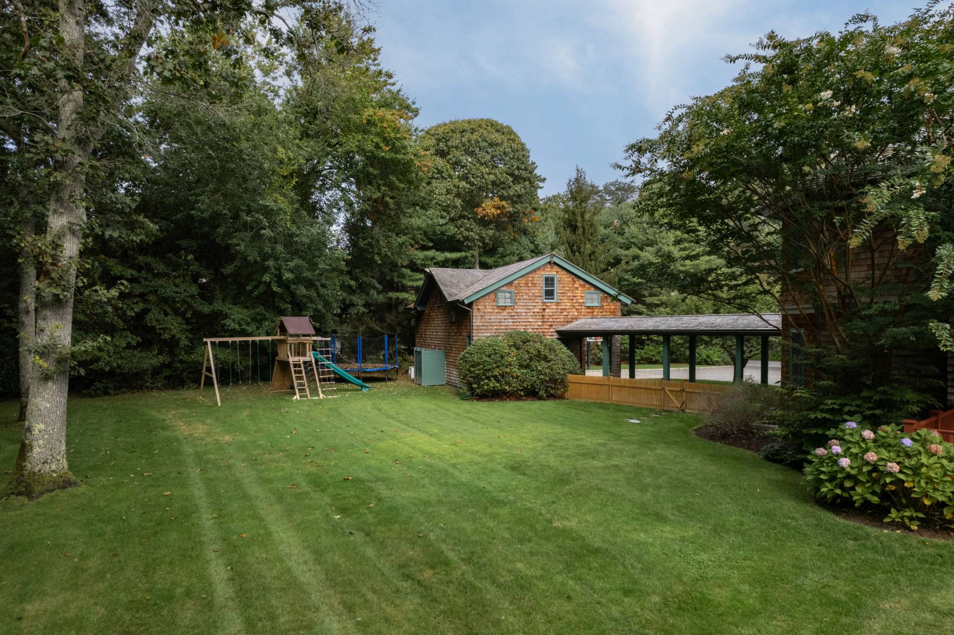 12 Old Point Road Quogue, NY 11959 - Photo 45 of 50 a backyard of a house with table and chairs