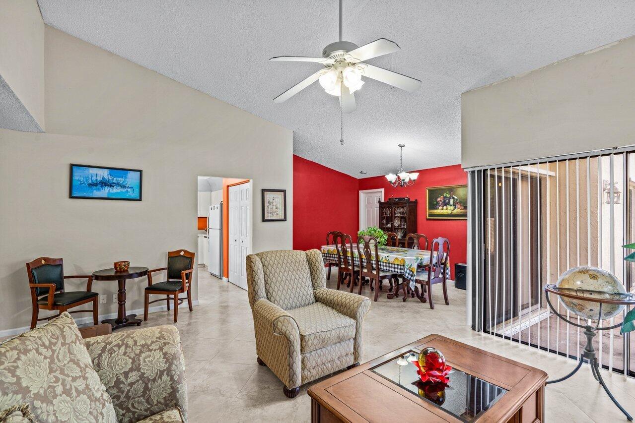 2195 Northwest 14th Street Delray Beach, FL 33445 - Photo 11 of 44 a living room with furniture and a chandelier