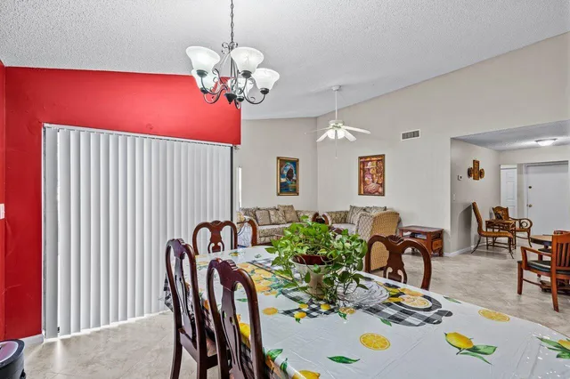 a view of a dining room with furniture and chandelier