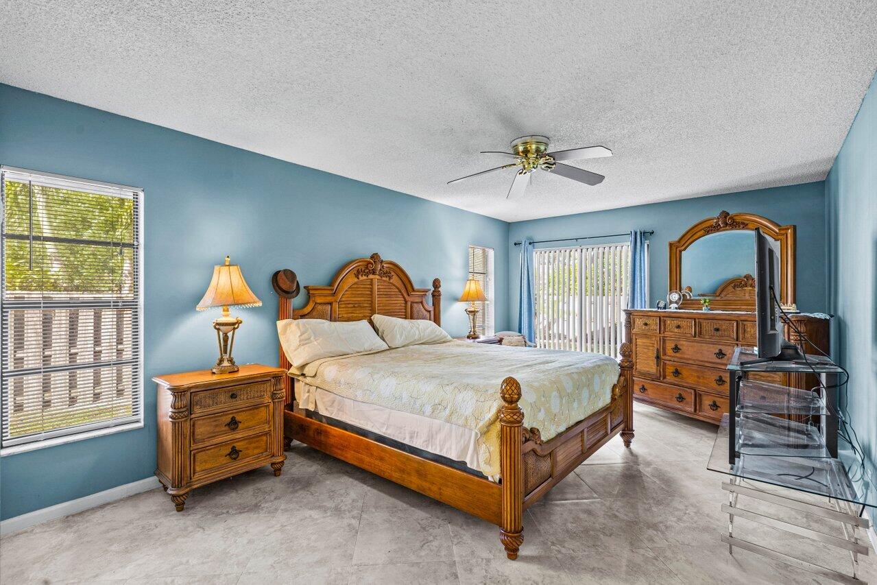 2195 Northwest 14th Street Delray Beach, FL 33445 - Photo 14 of 44 a bedroom with bed and windows
