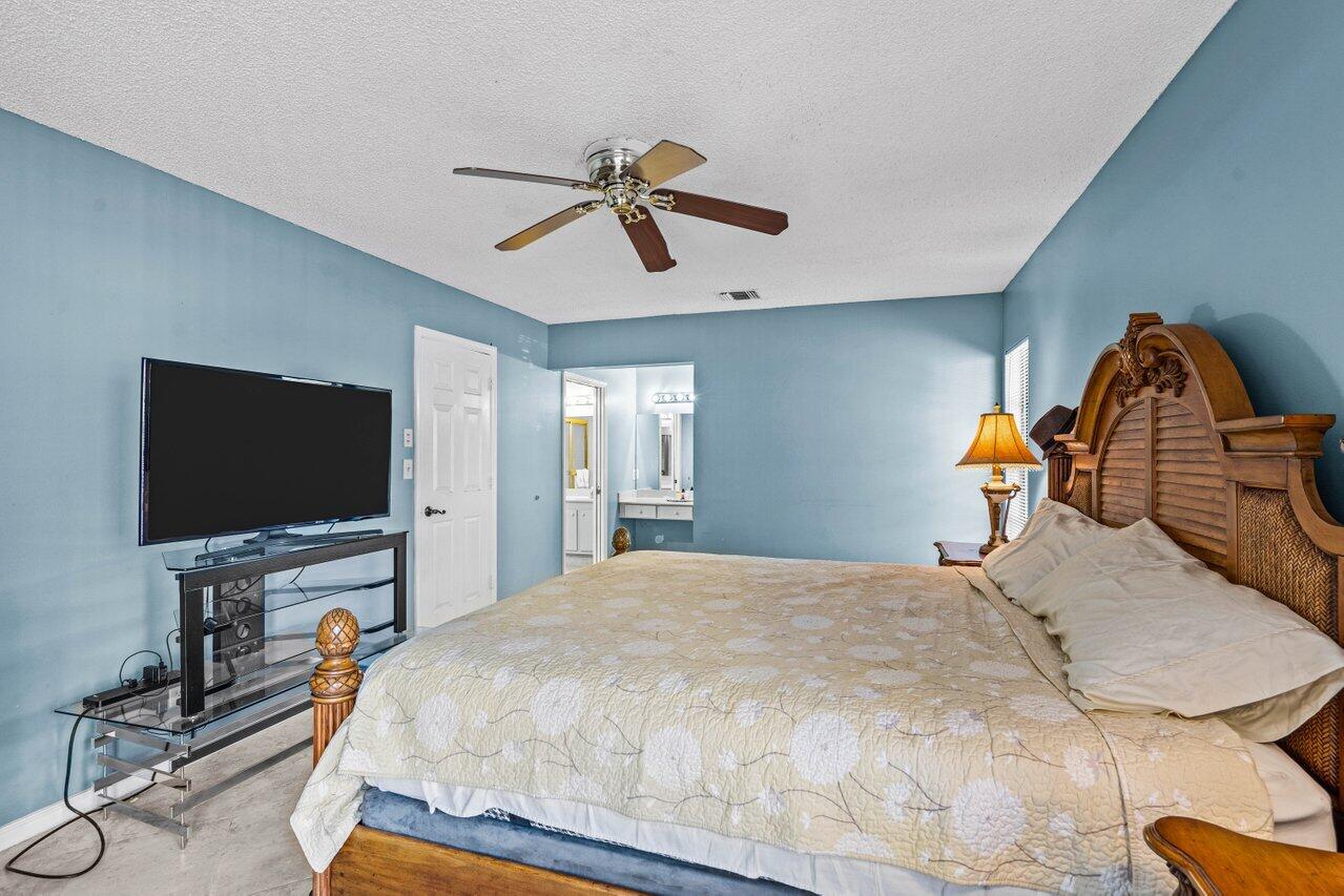 2195 Northwest 14th Street Delray Beach, FL 33445 - Photo 15 of 44 a bedroom with a bed and a flat screen tv