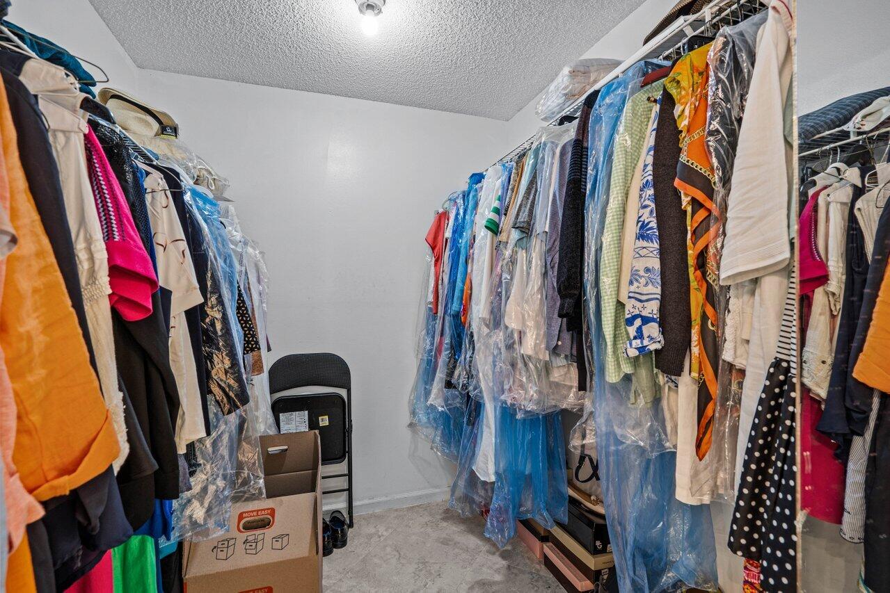 2195 Northwest 14th Street Delray Beach, FL 33445 - Photo 19 of 44 a view of walk in closet with clothes